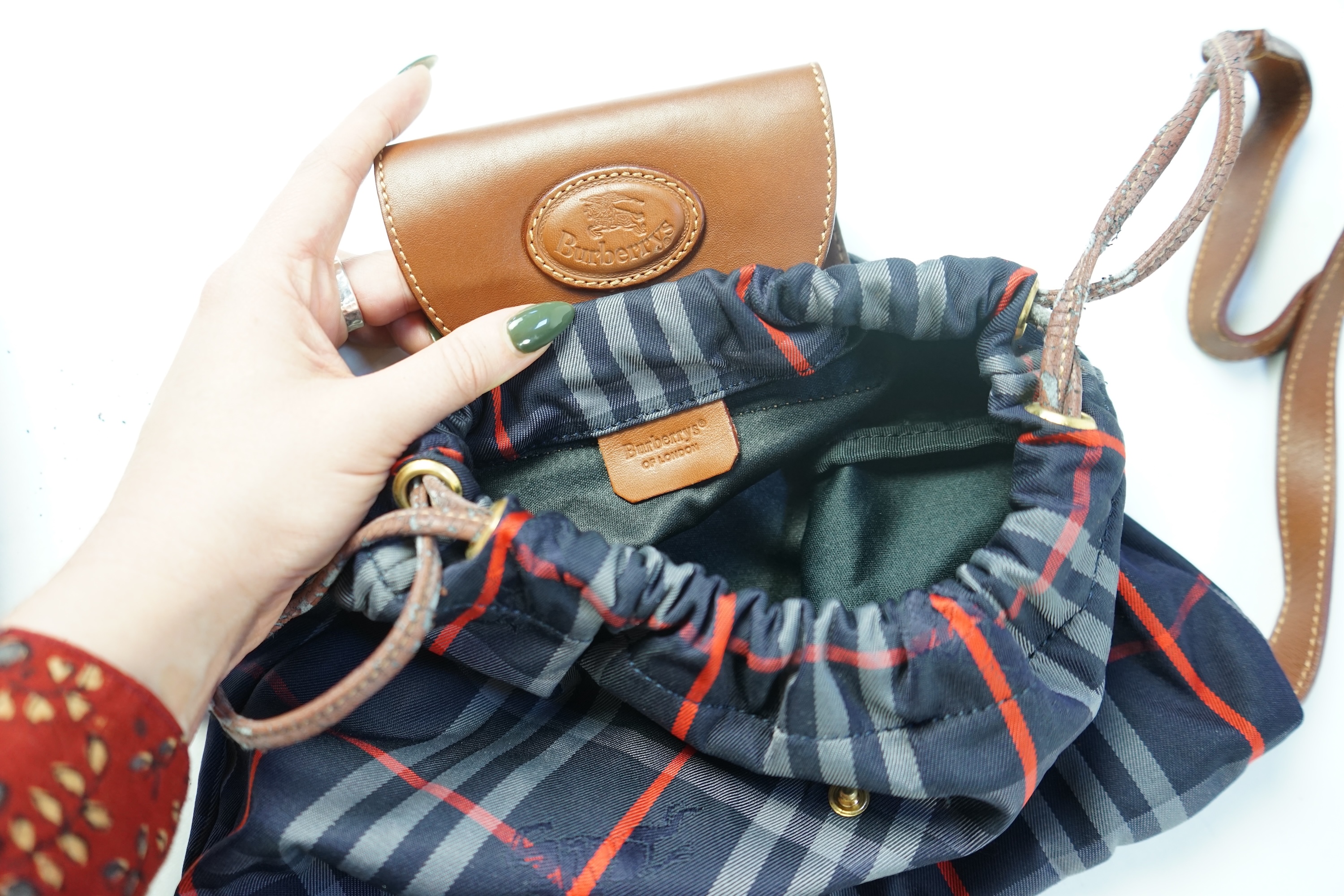 Two tartan canvas with leather trim Burberry bags, one backpack and one bucket bag